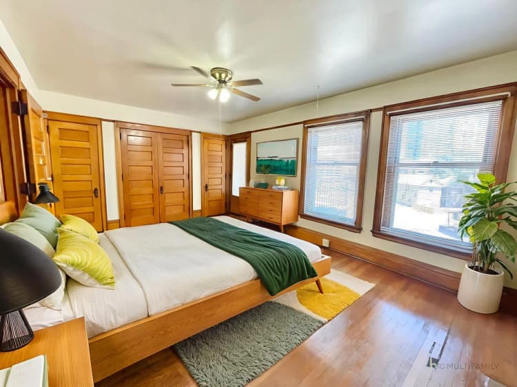 Kenosha apartments for rent - image - Inviting bedroom with natural light, featuring wooden accents, cozy bedding, and vibrant decor.