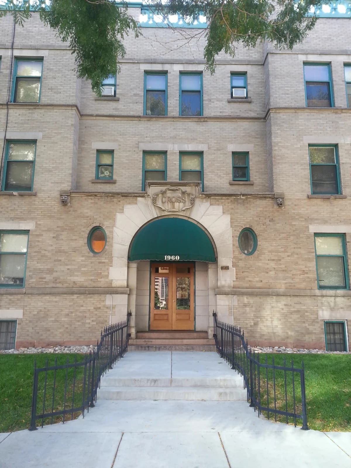 Kenosha apartments for rent - image - Historic brick apartment facade with green awnings and well-maintained entrance.