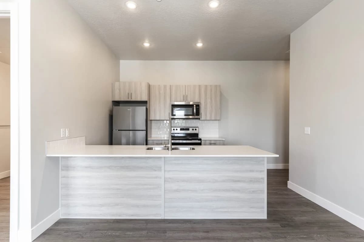 Kenosha apartments for rent - image - Modern kitchen with sleek cabinetry, stainless steel appliances, and a spacious countertop perfect for entertaining.