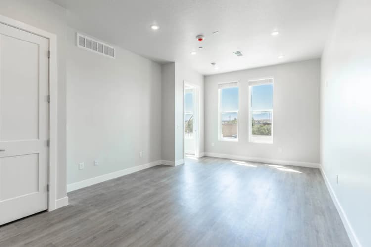 Kenosha apartments for rent - image - Bright, spacious living area with modern flooring, large windows offering natural light and scenic views.