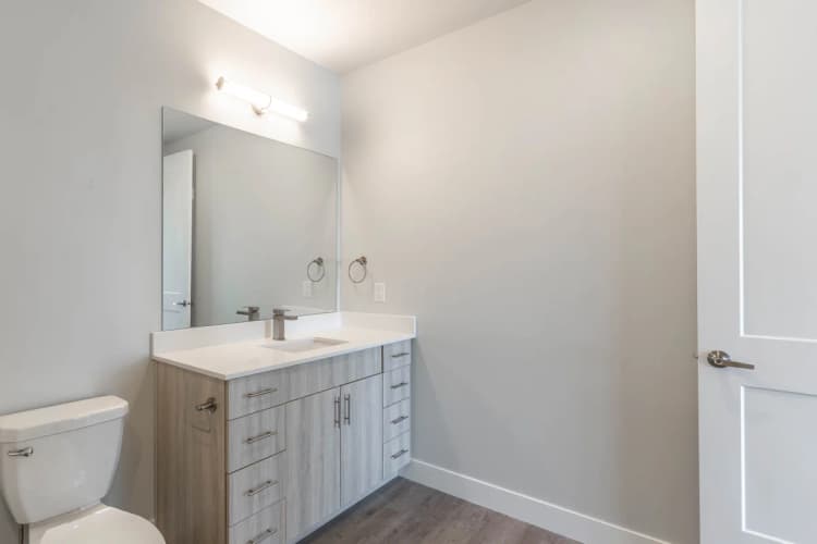Kenosha apartments for rent - image - Modern bathroom featuring sleek vanity with ample storage, elegant fixtures, and large mirror.