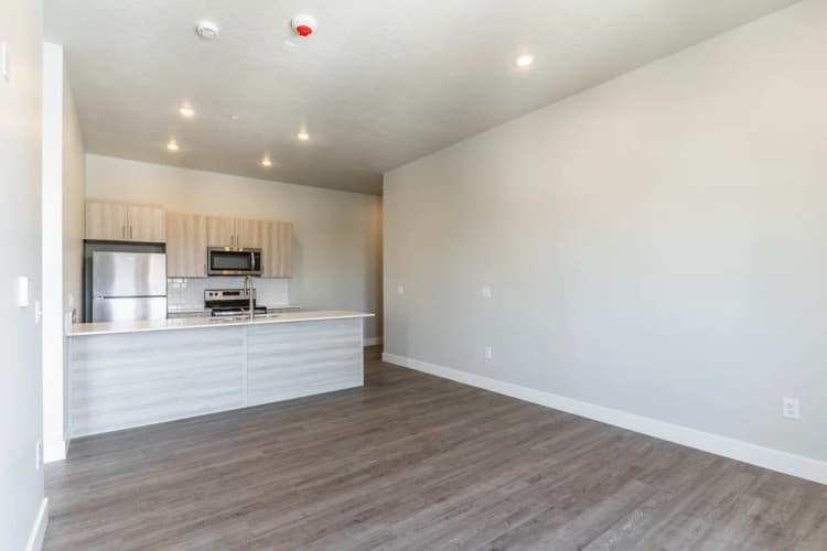 Kenosha apartments for rent - image - Modern open-concept kitchen with stainless steel appliances, elegant cabinetry, and spacious island in a bright, inviting apartment.